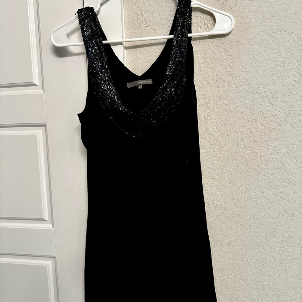 Black tank top with sequin detail.